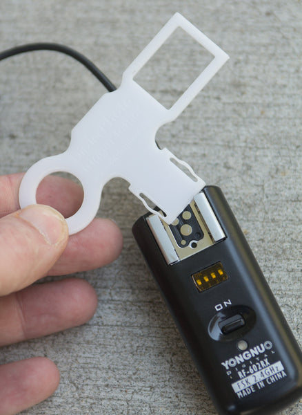 Trigger Tether shown being attached to flash remote reciever